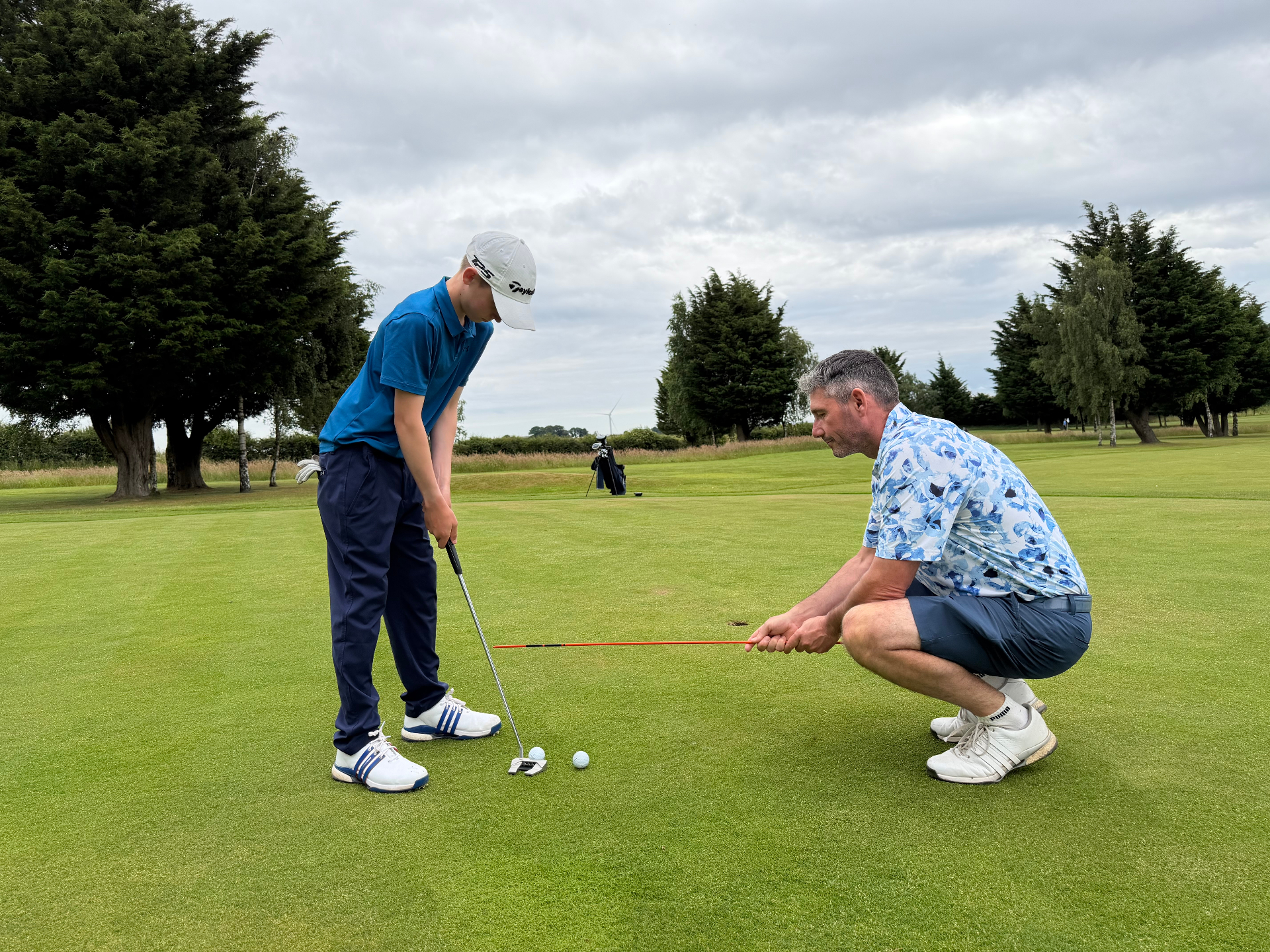 Peter Whiteford coaching a junior golfer in a bunker